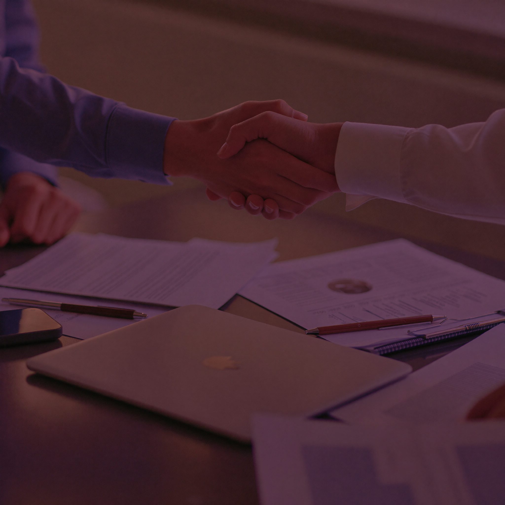 Handshake closing the acquisition deal in the office